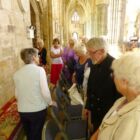 Members look at the tapestry