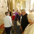 Members look at the tapestry